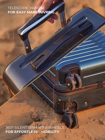Close-up of the Four Lamb telescopic handle and 360° silent spinner wheels on a beach surface.